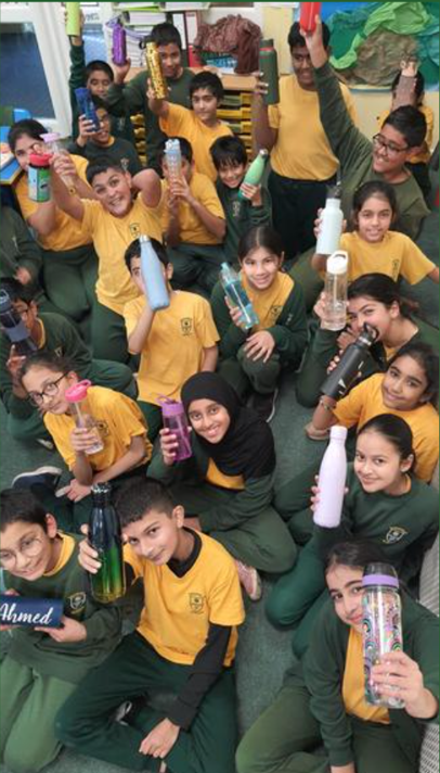 We have brought in our reusable water bottles to show we are going green!